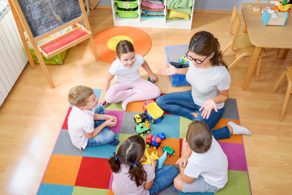 A Group of Children Happily Playing with Toys While Sitting on the Floor