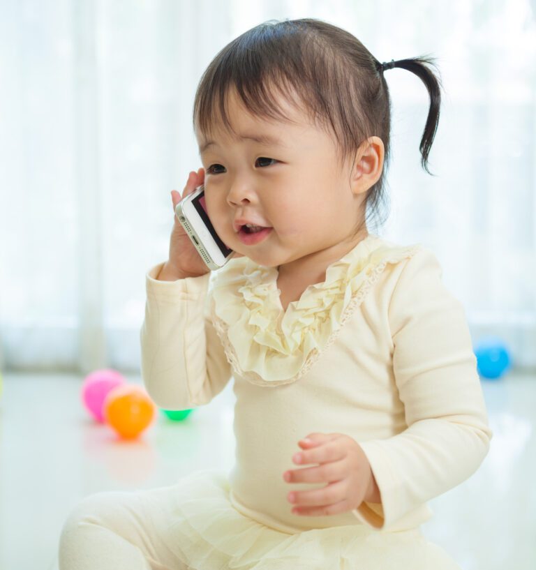 A Baby Girl Sitting on the Floor